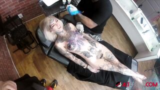 Sascha plays with Amber Luke while she gets tattooed